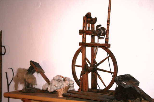 A 19th century spinning-wheel and accessories